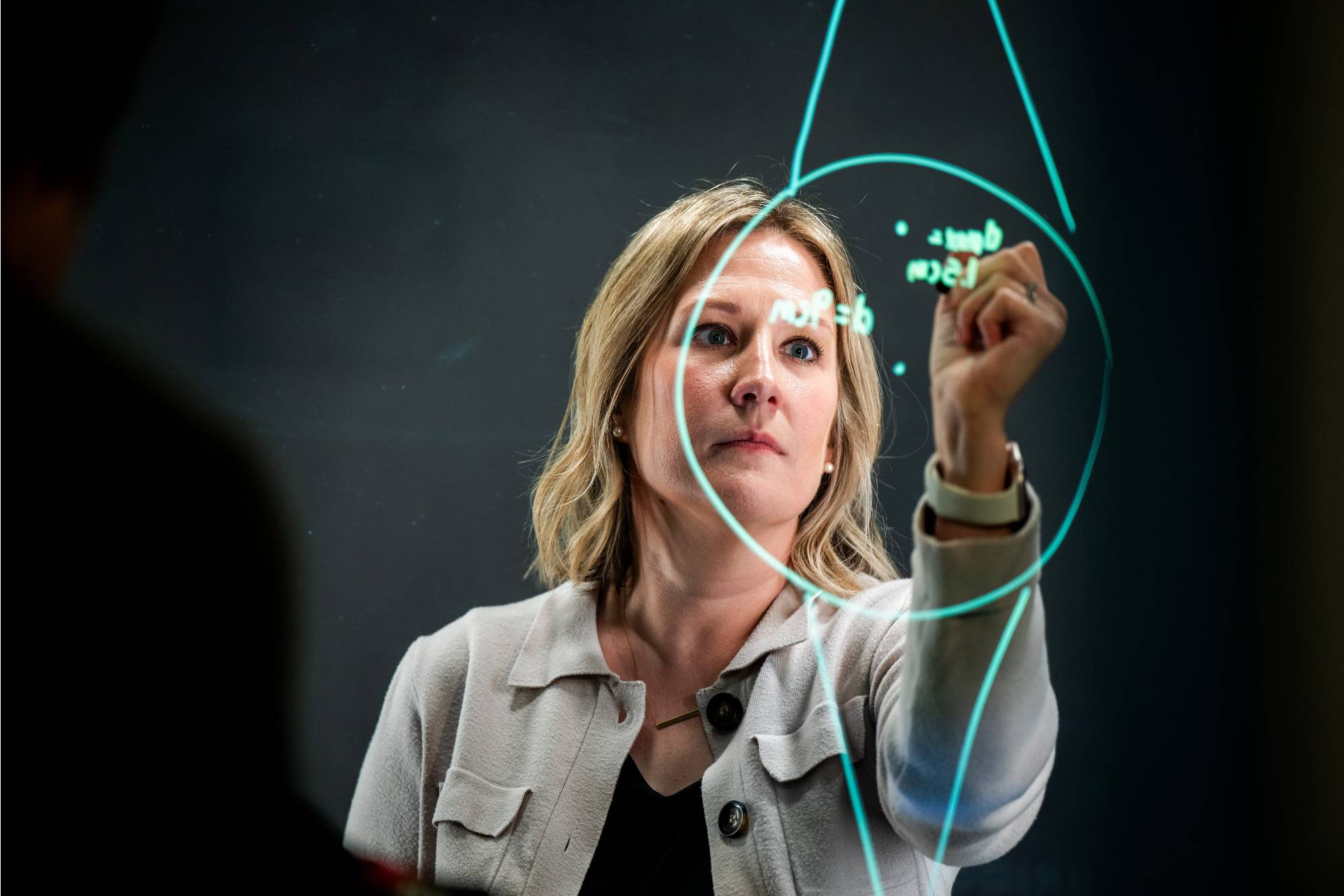 Kristen Vu writes on a screen in The Bridge